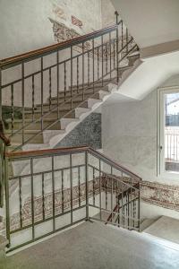 an empty staircase in a building with a window at LEONI DI COLLALTO PALACE in Treviso