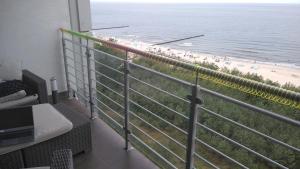 a balcony with a view of the beach at Baltic Beach View Porta Mare plaża in Dziwnówek