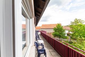 a balcony with chairs and a view of a building at Landhotel Georgshof in Hünfeld
