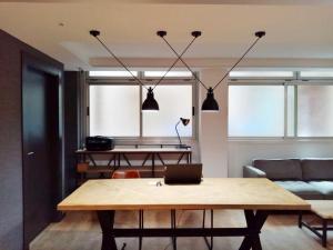 a living room with a table and a couch at BYPILLOW San Mamés in Bilbao