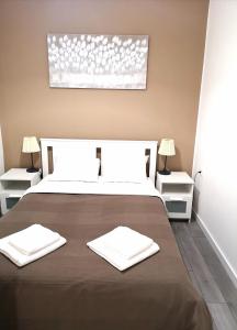 a bedroom with a bed with two white towels on it at Old Town in Pula