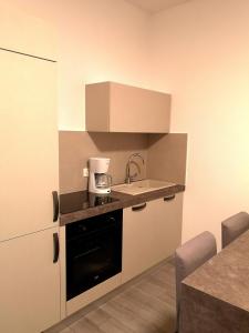 a small kitchen with a sink and a coffee maker at Old Town in Pula +12 photos