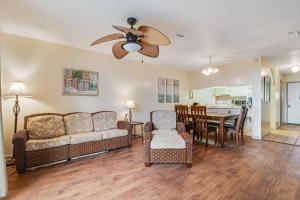 a living room with a couch and a dining room at Tarpon 10 in Panama City Beach