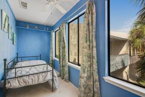 a bedroom with a bed and a window at Tarpon 10 in Panama City Beach