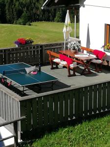 a ping pong table and benches on a patio at Almhaus Margit in Ebene Reichenau