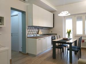 a kitchen with a table and a dining room at “I piccoli grani” delizioso BB vicino Vaticano in Rome