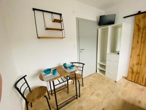 a room with a table and chairs and a tv at Relax in Ostrowo