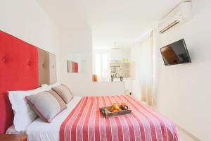 a bedroom with a bed with a tray of fruit on it at SorrentoVibes - Central Sorrento Apartment by PiazzaTasso&OldTown in Sorrento