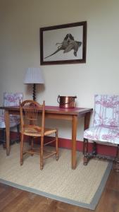 a room with a desk and a chair and a table at La Violiere in Rouziers-de-Touraine