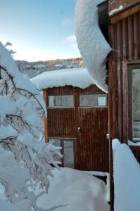 a building covered in snow with snow at Chalet Ciprés in Las Trancas