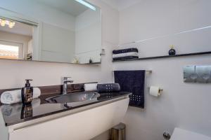 a bathroom with a sink and a mirror at Leonida in Mali Lošinj