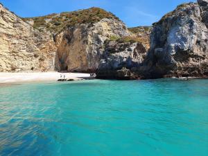 a beach with blue water and a rocky coastline at Mi Casa Su Casa in Montijo