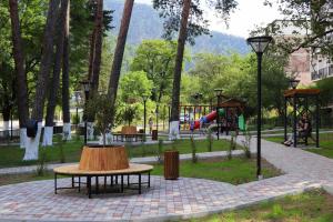 a park with a table with a log on it at Family Hotel Chino in Borjomi
