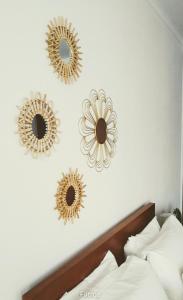 three mirrors on a wall above a bed at Mi Casa Su Casa in Montijo