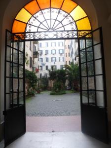 an open door to a courtyard with a building at Giovy in Rome