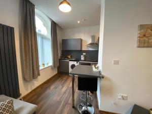 a small kitchen with a table in a room at Self catering Skipton town centre apartment in Skipton