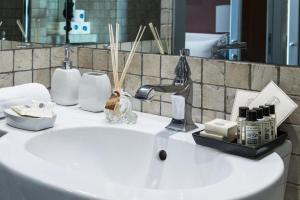 a bathroom sink with cosmetics and a mirror at Fontana di Trevi Luxury Nest in Rome