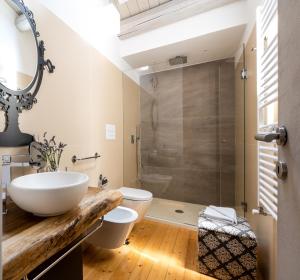 a bathroom with a sink and a toilet and a shower at I Carusi Relais in Noto