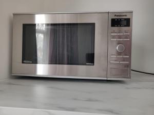 a microwave oven sitting on top of a counter at Stunning Double Room in Harrow Wembley - Khoob House in London