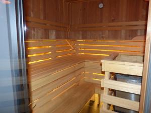 a sauna with wooden walls and a wooden floor at Appartements Alpenland in Lermoos