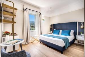 a hotel room with a bed and a window at Hotel Mediterraneo in Sant'Agnello