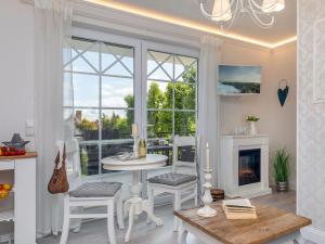 a living room with a table and a fireplace at Ostseetraum in Zingst