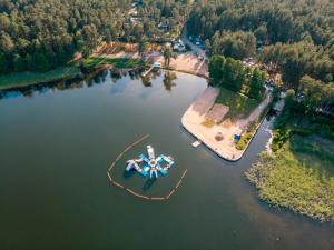 an aerial view of a lake with a boat in the water at Chill&Grill camping in Daugavpils