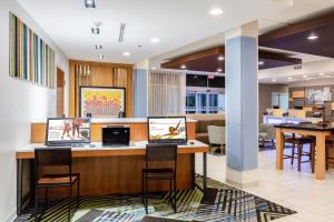 a lobby with two laptops on a counter at Holiday Inn Express Calhoun South, an IHG Hotel in Calhoun