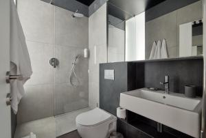 a bathroom with a shower and a toilet and a sink at Atmosfera Hotel in Odesa +36 photos