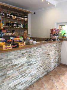 a bar in a restaurant with a brick wall at U Eli in Wambierzyce