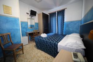 Postel nebo postele na pokoji v ubytování Hotel Napoleone