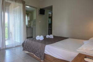Postel nebo postele na pokoji v ubytování Kalouda Rooms