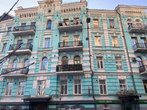 a tall blue building with windows and balconies at Kiev Lodging in Kyiv