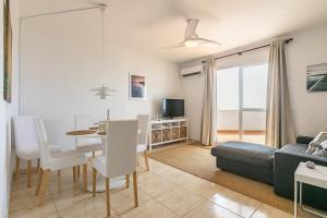 a living room with a couch and a dining room at Two bedroom penthouse in Torremuelle Benalmádena in Benalmádena