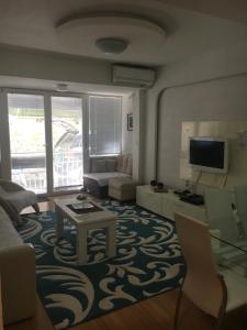 a living room with a couch and a table at Between the lake and the forest in Ohrid