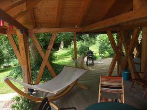 a hammock on a deck in a pavilion at Ferienhaus Hubertus in Elend mit Balkons in Elend