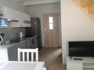 a kitchen with a table and a tv in a room at Agro-Luz in Miastko
