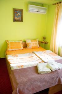 two beds in a room with green walls at Zajazd U Julii in Miastko