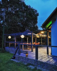 達魯旺姆芙的住宿－Ośrodek VolfCamp Kwaszenina，庭院在晚上配有桌子和遮阳伞