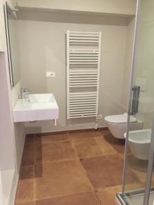 a bathroom with a white sink and a toilet at Green B&B Urbino Cá del vento in Urbino +60 photos