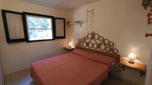 Ένα ή περισσότερα κρεβάτια σε δωμάτιο στο Villino Marzellinu Belvedere