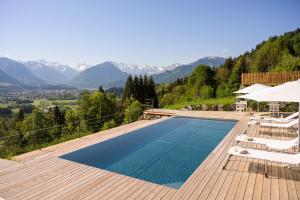 a swimming pool with a view of the mountains at Der Jägersberg in Fischen