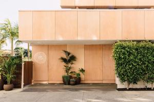 a building with plants in front of it at Hotel June, Los Angeles, a Member of Design Hotels in Los Angeles