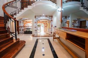 a large hallway with stairs and a tile floor at Casa Frida Cozumel in Cozumel