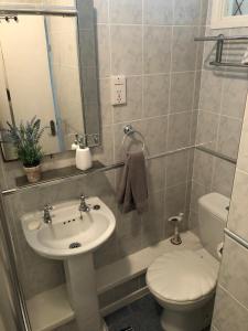a bathroom with a sink and a toilet at Redcliffe Apartments Flat 7A in Swansea