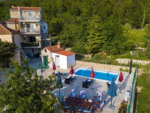 an aerial view of a pool with tables and umbrellas at Villa in Tu epi with Private Swimming Pool in Tučepi