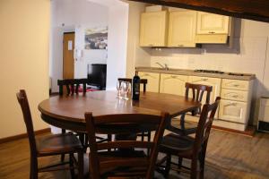a kitchen with a table with chairs and a bottle of wine at Era Rental Apartments in Florence
