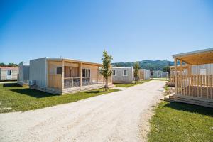 a group of modular homes on a dirt road at Mediteran Homes with Terme Čatež Tickets in Čatež ob Savi