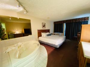 A bed or beds in a room at Fleetwood Inn Suites