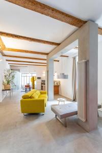 ein Wohnzimmer mit einem gelben Sofa und einem Tisch in der Unterkunft Chic et moderne in Marseille